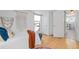 Bright, airy bedroom featuring a boho decor, hardwood floors, and an adjacent laundry room at 28 Peachtree Hills Ne Ave, Atlanta, GA 30305