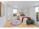 Bright bedroom with a colorful rug, natural light, and stylish decor at 28 Peachtree Hills Ne Ave, Atlanta, GA 30305