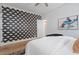 Serene bedroom featuring wallpaper accent wall, hardwood floors, and natural light at 28 Peachtree Hills Ne Ave, Atlanta, GA 30305