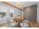 Modern dining room with wood table, stylish chairs, and stone accent wall at 28 Peachtree Hills Ne Ave, Atlanta, GA 30305