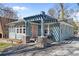 Charming blue home featuring a unique pergola over the front porch and a pink front door at 28 Peachtree Hills Ne Ave, Atlanta, GA 30305