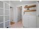 Bright hallway featuring built-in storage, charming decor, and unique hexagonal floor tiles, adding character to the home at 28 Peachtree Hills Ne Ave, Atlanta, GA 30305