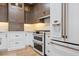 Gourmet kitchen featuring stainless appliances, gas range, custom cabinetry, and hardwood floors at 28 Peachtree Hills Ne Ave, Atlanta, GA 30305