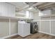 Bright laundry area featuring modern washer and dryer, cabinets and wood look flooring at 28 Peachtree Hills Ne Ave, Atlanta, GA 30305