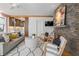 Inviting living room with stone fireplace, stylish furniture, and open view to the modern kitchen at 28 Peachtree Hills Ne Ave, Atlanta, GA 30305