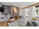 Inviting living room features a stone fireplace, built-in shelves, and a doorway to another room at 28 Peachtree Hills Ne Ave, Atlanta, GA 30305