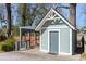 Exterior view of a quaint backyard shed with a covered patio and seating area at 28 Peachtree Hills Ne Ave, Atlanta, GA 30305
