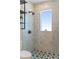 Shower area with clear glass enclosure, tiled walls, a showerhead, and a window with small decor for natural light at 28 Peachtree Hills Ne Ave, Atlanta, GA 30305