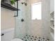 Stylish bathroom shower with glass enclosure, tiled walls, a showerhead, and a window for natural light at 28 Peachtree Hills Ne Ave, Atlanta, GA 30305
