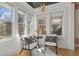Charming sitting area features stylish chairs, a small table, and natural light from three windows at 28 Peachtree Hills Ne Ave, Atlanta, GA 30305