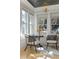 Bright sitting area features stylish chairs, a small table, and natural light from three windows at 28 Peachtree Hills Ne Ave, Atlanta, GA 30305