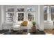 Cozy sunroom with a bench, decorative pillows, and a large window overlooking the front yard at 28 Peachtree Hills Ne Ave, Atlanta, GA 30305