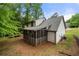 Home featuring a screened porch, set within a lush, green backyard at 4934 Woodstream Nw Ln, Acworth, GA 30102