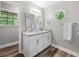 Bright bathroom features double vanity and octagon window at 4934 Woodstream Nw Ln, Acworth, GA 30102