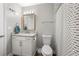 Bathroom with granite countertops, framed mirror, and a shower with a patterned curtain at 4934 Woodstream Nw Ln, Acworth, GA 30102