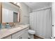 Bathroom with granite countertops, framed mirror, and a shower with a patterned curtain at 4934 Woodstream Nw Ln, Acworth, GA 30102