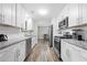 Bright kitchen features white cabinets, granite counters, stainless steel appliances, and modern subway tile backsplash at 4934 Woodstream Nw Ln, Acworth, GA 30102