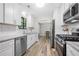 Bright kitchen features white cabinets, granite counters, stainless steel appliances, and modern subway tile backsplash at 4934 Woodstream Nw Ln, Acworth, GA 30102