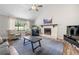 Comfortable living room featuring a fireplace, large window, and hardwood floors at 4934 Woodstream Nw Ln, Acworth, GA 30102