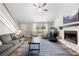 Comfortable living room boasts a stone fireplace, large windows, and hardwood floors at 4934 Woodstream Nw Ln, Acworth, GA 30102