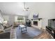 Cozy living room featuring a stone fireplace, vaulted ceilings, and ample natural light at 4934 Woodstream Nw Ln, Acworth, GA 30102