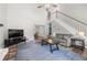 Open concept living area with vaulted ceiling, fireplace, and staircase to the upper level at 4934 Woodstream Nw Ln, Acworth, GA 30102