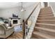 Inviting view of the carpeted staircase leading to the upper level, adjacent to the living area at 4934 Woodstream Nw Ln, Acworth, GA 30102