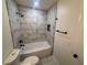 Modern bathroom with marble-style tiled walls and black fixtures in shower/tub area at 600 Mary Erna Dr, Fairburn, GA 30213