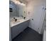 A bathroom with double sinks, large mirror, and modern tile in the shower at 600 Mary Erna Dr, Fairburn, GA 30213
