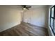 This bedroom features light-toned walls, wood flooring and an overhead fan with light at 600 Mary Erna Dr, Fairburn, GA 30213