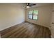 Bedroom with a neutral color palette, window view, and modern ceiling fan at 600 Mary Erna Dr, Fairburn, GA 30213