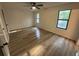 Bright bedroom with wood flooring, large windows, and modern ceiling fan at 600 Mary Erna Dr, Fairburn, GA 30213