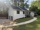 Charming home featuring fresh white siding, black roof, a convenient garage, and inviting curb appeal at 600 Mary Erna Dr, Fairburn, GA 30213