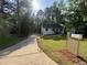Traditional single-Gathering home featuring lush front lawn, driveway, mature trees, and a wooden mailbox at 600 Mary Erna Dr, Fairburn, GA 30213