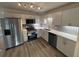 Modern kitchen featuring stainless steel appliances, sleek countertops, white cabinets, and stylish backsplash at 600 Mary Erna Dr, Fairburn, GA 30213