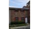 Charming brick townhome featuring red shutters and a well-maintained front yard at 6354 Shannon Pkwy # 20D, Union City, GA 30291