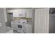 Bright kitchen features white cabinets, appliances, marble counters and tiled backsplash at 6354 Shannon Pkwy # 20D, Union City, GA 30291