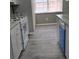 Kitchen with a window, gray flooring, white cabinets, counters, and stainless appliances at 6354 Shannon Pkwy # 20D, Union City, GA 30291
