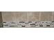Shower tile with a decorative band of varying tones at 6354 Shannon Pkwy # 20D, Union City, GA 30291