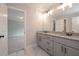 Bathroom boasting double vanity with granite countertops, gray cabinets, and marble flooring at 6861 Ga Hwy 5, Douglasville, GA 30135