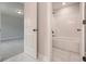 Bathroom showcases tiled shower/tub combo, marble floors, and white door to another room at 6861 Ga Hwy 5, Douglasville, GA 30135