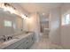 Well-lit bathroom with granite countertops and access to the shower and the hallway at 6861 Ga Hwy 5, Douglasville, GA 30135