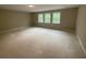 Unfinished bedroom with three large windows and neutral paint awaiting personalization at 6861 Ga Hwy 5, Douglasville, GA 30135