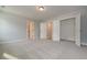 Spacious carpeted bedroom featuring a walk in closet, doorways and light gray walls at 6861 Ga Hwy 5, Douglasville, GA 30135