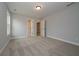 Spacious bedroom with soft carpet, light gray walls, and multiple doorways at 6861 Ga Hwy 5, Douglasville, GA 30135