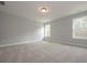 A bonus room featuring neutral decor, carpet, and lots of bright, natural light from a large window at 6861 Ga Hwy 5, Douglasville, GA 30135
