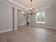 Spacious dining room with a tray ceiling, chandelier, and large windows allowing natural light to flow through at 6861 Ga Hwy 5, Douglasville, GA 30135