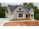 New construction home featuring a three-car garage and neutral-toned exterior with white trim at 6861 Ga Hwy 5, Douglasville, GA 30135