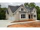 New construction home featuring a three-car garage and neutral-toned exterior with white trim at 6861 Ga Hwy 5, Douglasville, GA 30135