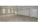 Spacious three car garage with concrete flooring, an abundance of lighting and neutral paint at 6861 Ga Hwy 5, Douglasville, GA 30135